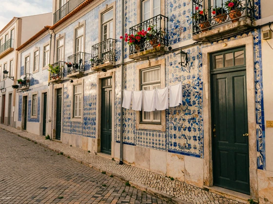 Charming Lisbon Alfama street with azulejo tiles and cobblestones - Portuguese dating culture and lifestyle